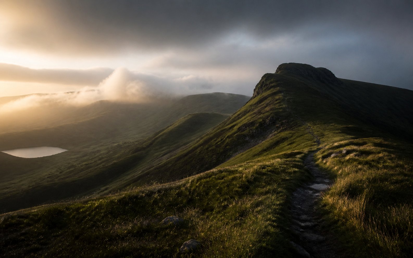 A dramatic green mountain trail in early morning light